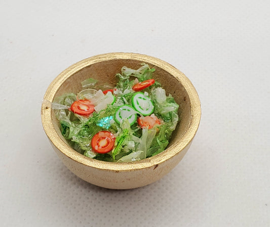 salad in wooden bowl with gold rim